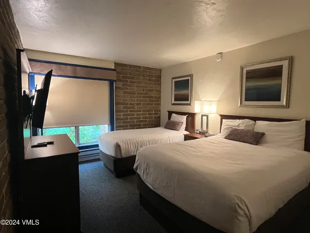 a bedroom with bed and window