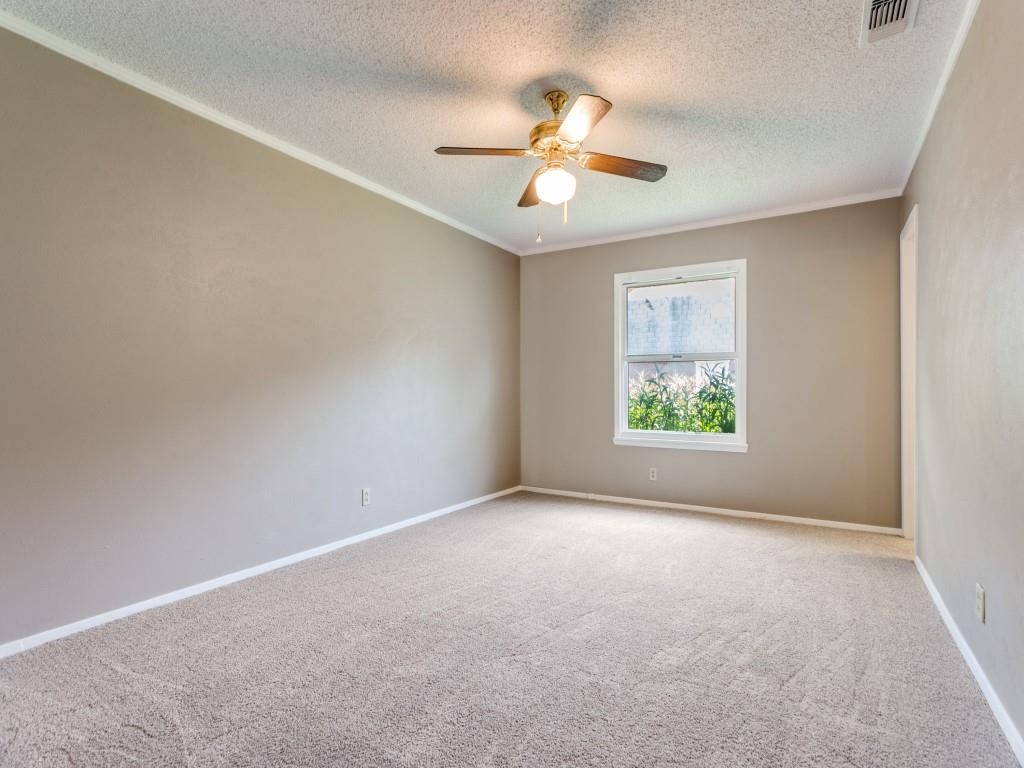 1216 Manning Street Benbrook, TX 76126 - Photo 12 of 26 Unfurnished room featuring ornamental molding, carpet floors, a textured ceiling, and a ceiling fan