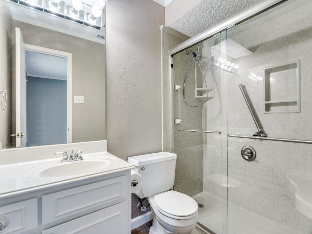 1216 Manning Street Benbrook, TX 76126 - Photo 13 of 26 Bathroom with vanity, a textured wall, a stall shower, and crown molding