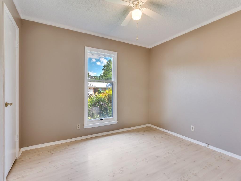 1216 Manning Street Benbrook, TX 76126 - Photo 14 of 26 Spare room featuring ornamental molding, light wood finished floors, a textured ceiling, and ceiling fan
