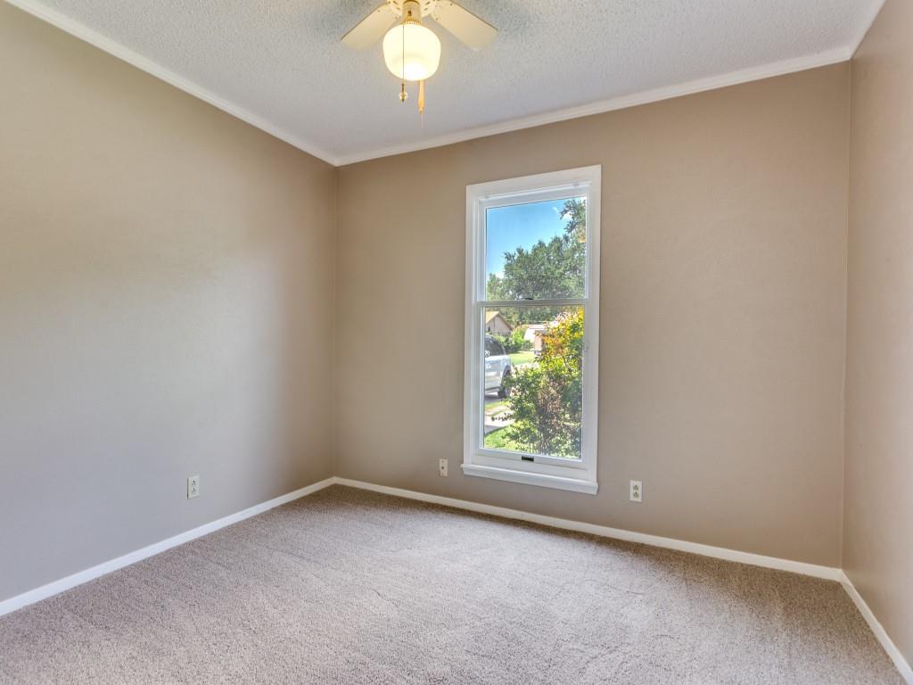 1216 Manning Street Benbrook, TX 76126 - Photo 15 of 26 Carpeted spare room featuring crown molding, a textured ceiling, and ceiling fan