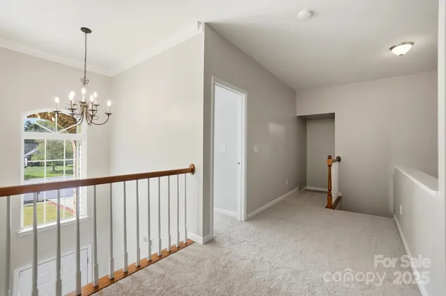 a view of a chandelier in big room and chandelier fan