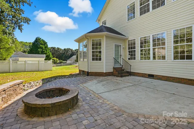 a view of a house with swimming pool and sitting area