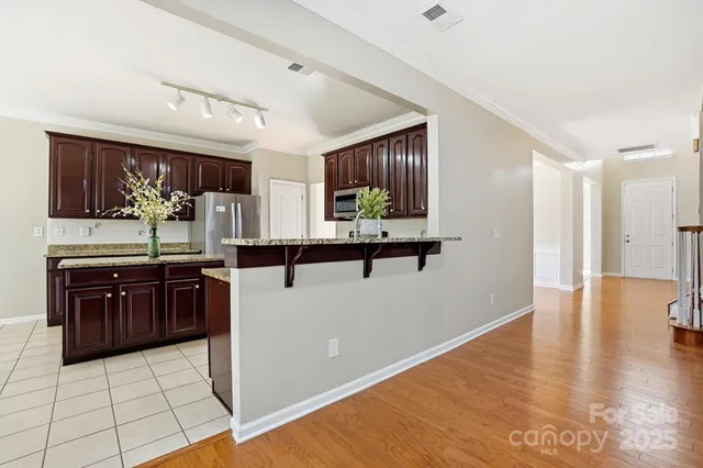 a kitchen with stainless steel appliances granite countertop a refrigerator and a sink