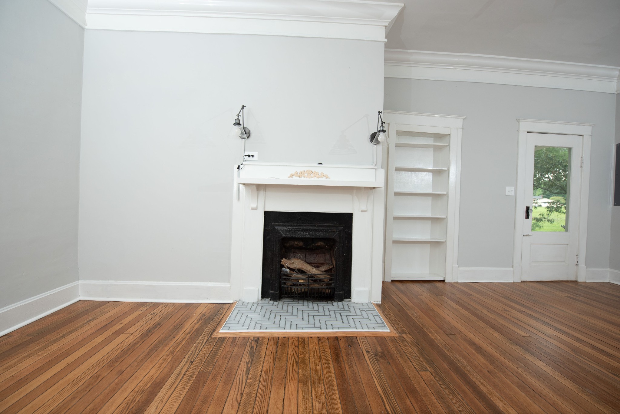 3058 Lipscomb Road Springfield, TN 37172 - Photo 6 of 19 a view of an empty room with wooden floor fireplace and a window