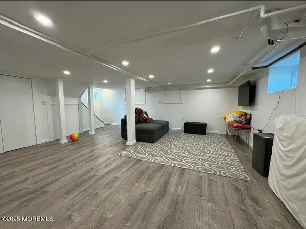a view of living room with furniture and a wooden floor