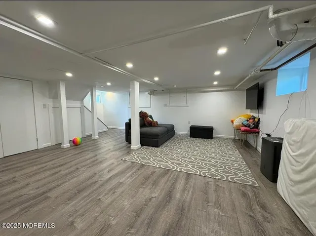 a view of living room with furniture and a wooden floor