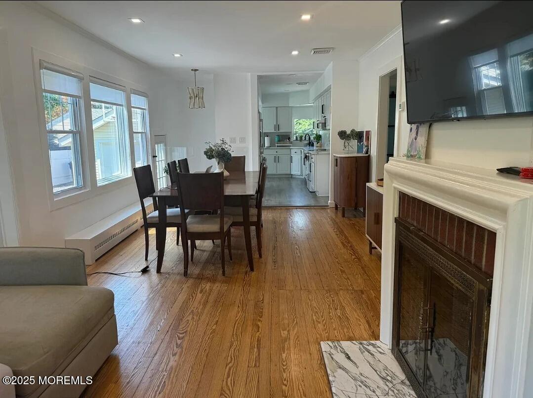 184 Ridgewood Avenue Oakhurst, NJ 07755 - Photo 3 of 16 a view of a dining room with furniture and wooden floor