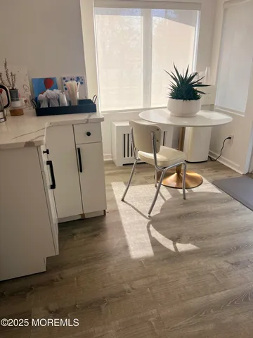 a view of a workspace with furniture and a potted plant
