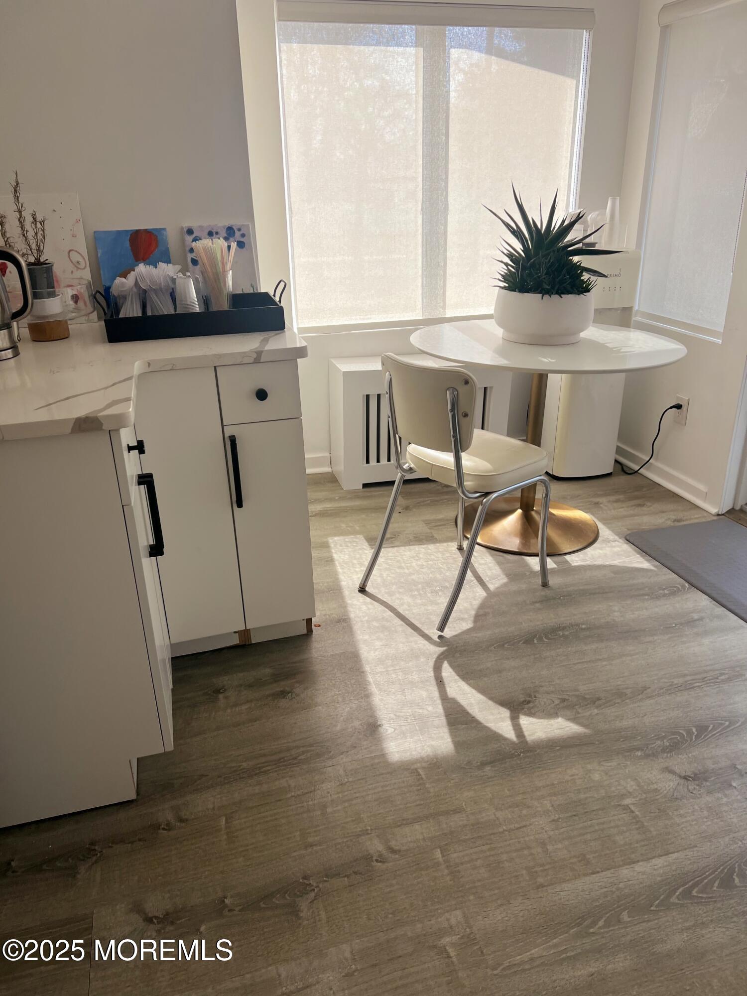 184 Ridgewood Avenue Oakhurst, NJ 07755 - Photo 5 of 16 a view of a workspace with furniture and a potted plant