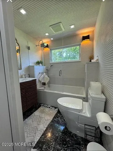 a bathroom with a sink toilet and mirror
