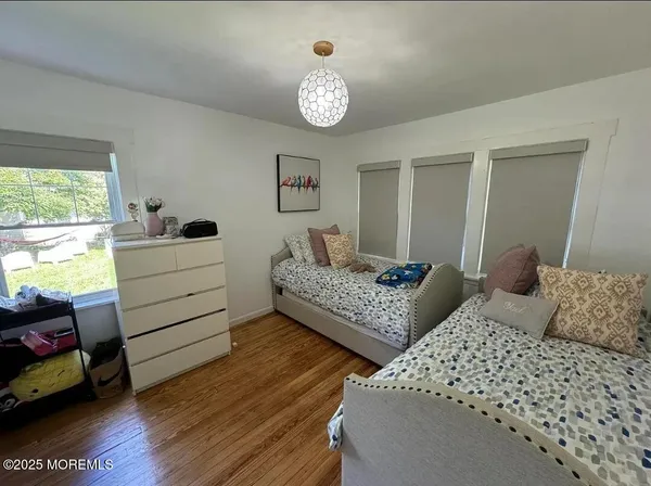 a bedroom with two beds and a chandelier