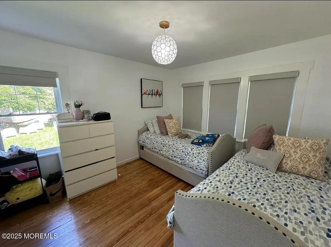 184 Ridgewood Avenue Oakhurst, NJ 07755 - Photo 10 of 16 a bedroom with two beds and a chandelier
