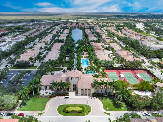 an aerial view of residential houses with outdoor space and swimming pool