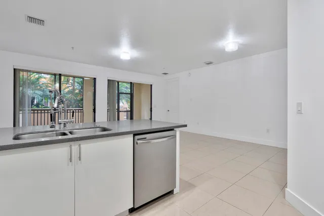 a kitchen with kitchen island a counter top space and cabinets