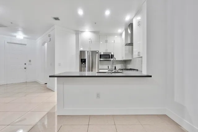 a kitchen with granite countertop cabinets and window