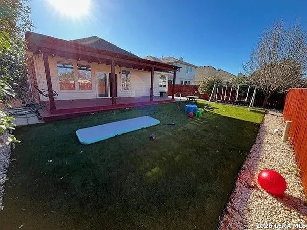a view of a house with backyard and porch