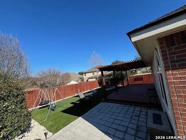 a view of a backyard with wooden fence