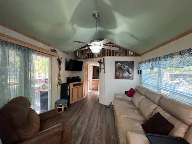 a kitchen with stainless steel appliances a refrigerator sink and wooden floor
