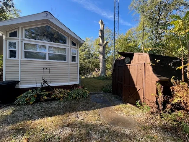 a view of house with yard in front of it