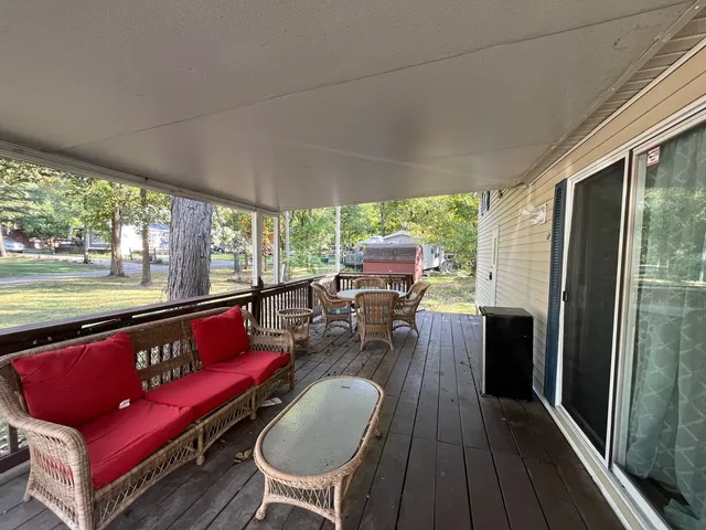a view of a wooden deck and a backyard