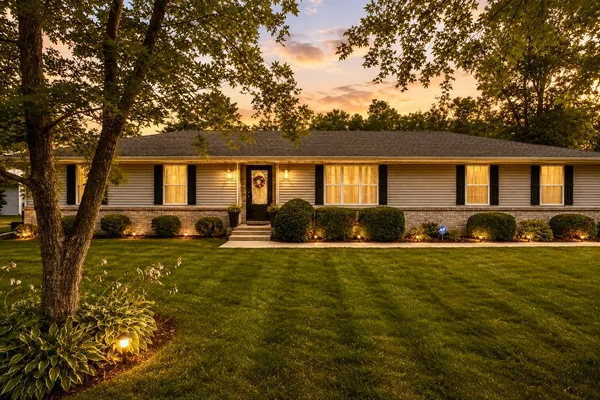 a front view of house with yard having outdoor seating
