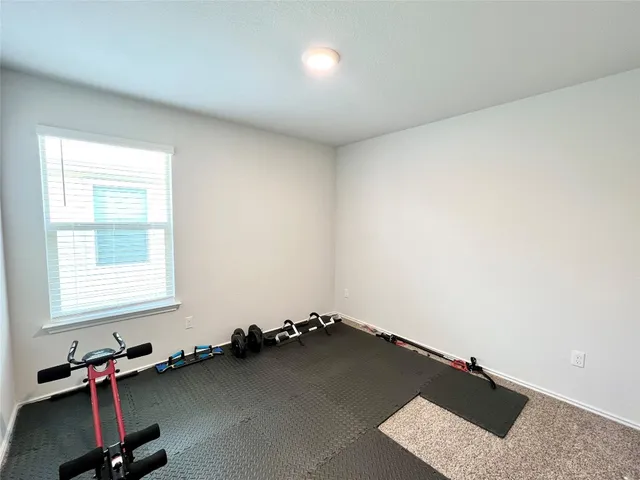 a large kitchen with stainless steel appliances granite countertop a stove oven a sink a refrigerator a stove a dining table and chairs