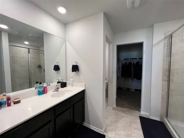a bathroom with a bathtub shower sink and a toilet