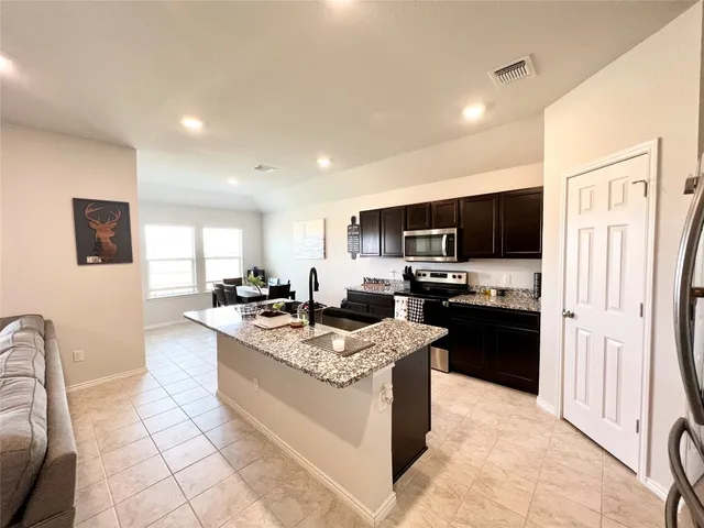 a backyard of a house with table and chairs