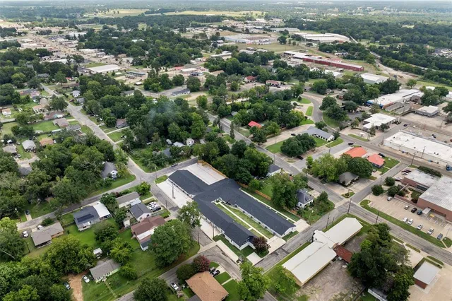 an aerial view of a house with a yard