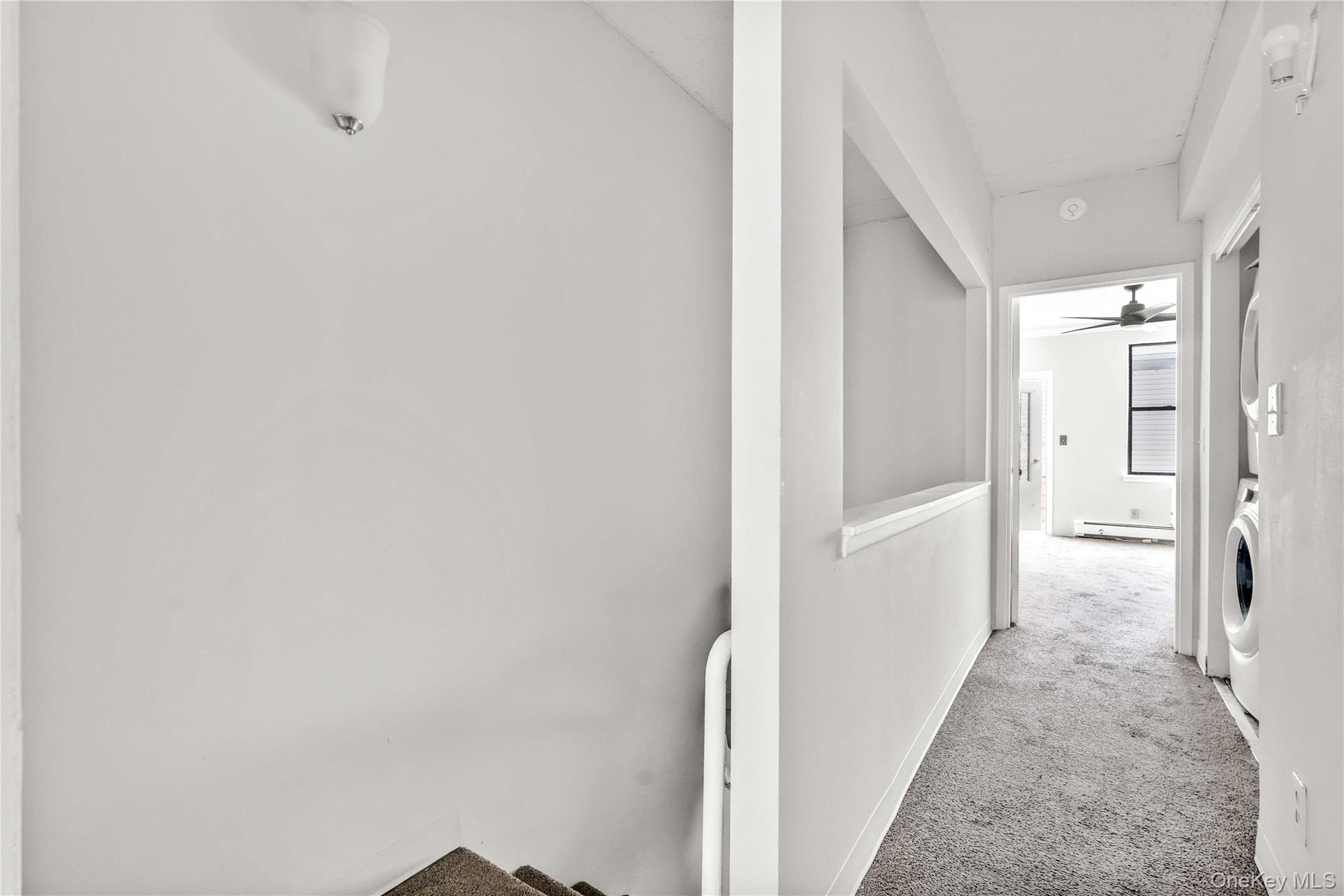 758 Brook Avenue, Unit 56C Bronx, NY 10455 - Photo 13 of 16 Corridor featuring light colored carpet and a baseboard radiator