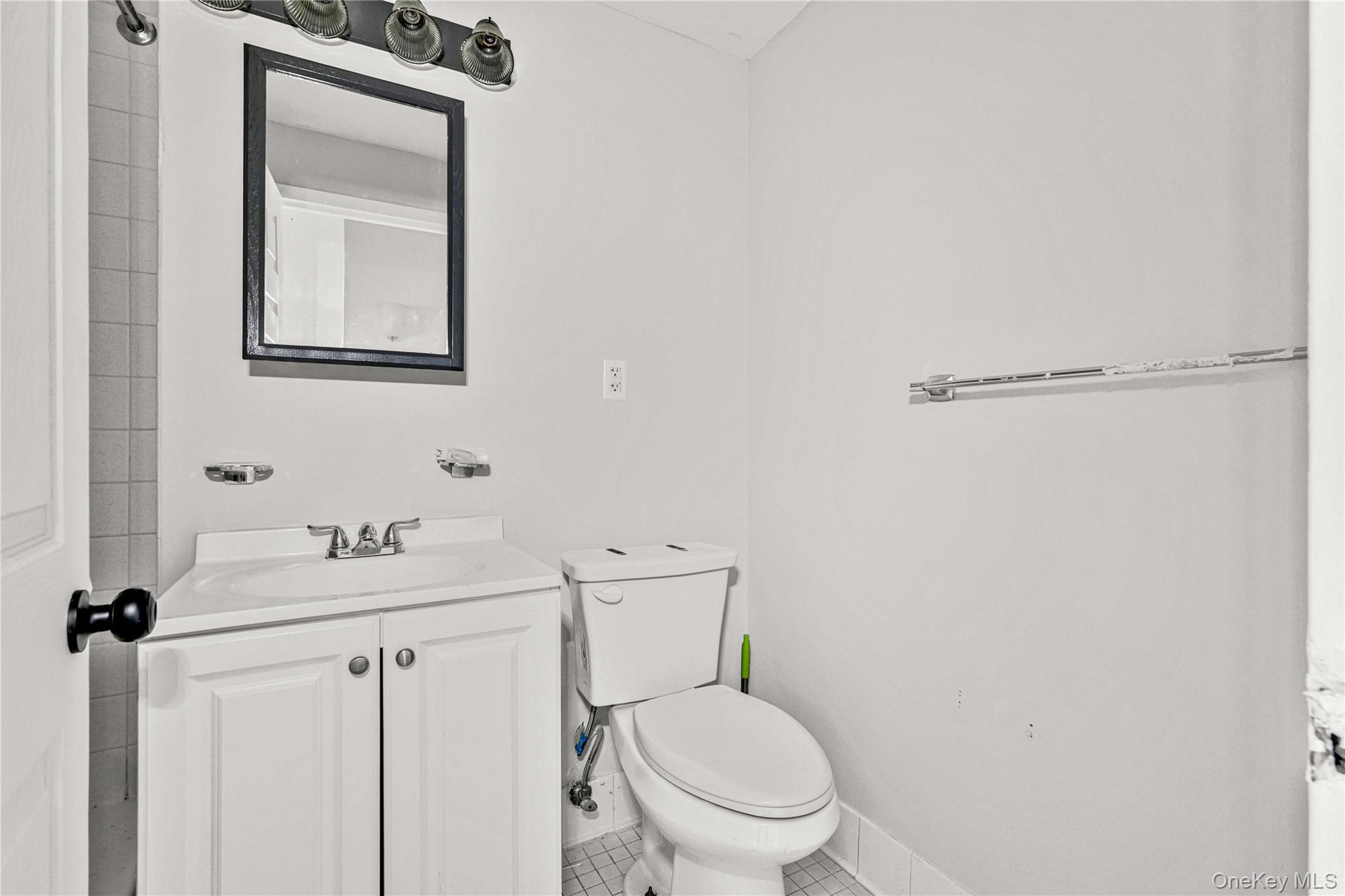 758 Brook Avenue, Unit 56C Bronx, NY 10455 - Photo 7 of 16 Half bath with vanity and tile patterned flooring