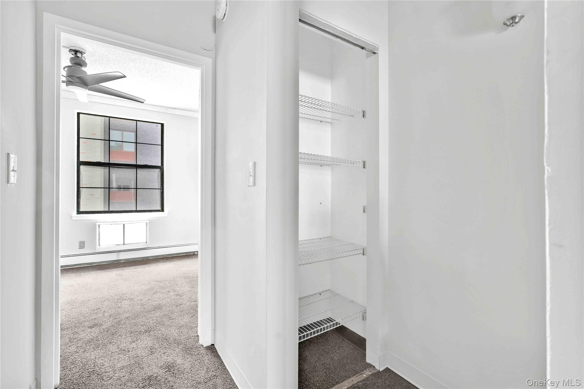 758 Brook Avenue, Unit 56C Bronx, NY 10455 - Photo 9 of 16 Closet featuring a baseboard radiator