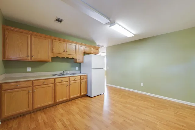 a kitchen with granite countertop a sink and a stove top oven