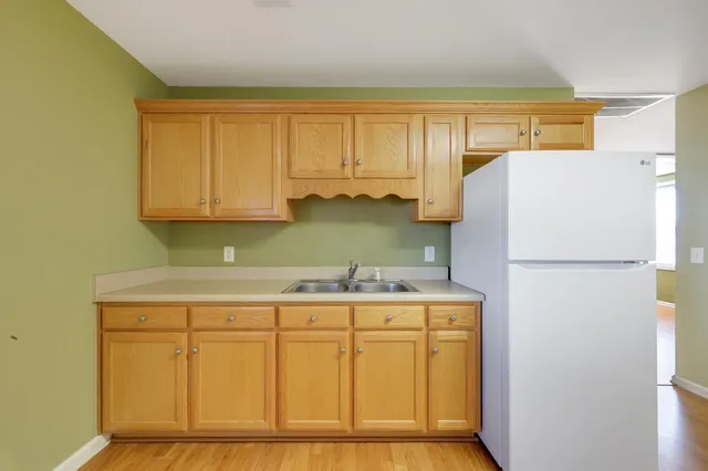 a kitchen with a refrigerator a stove top oven