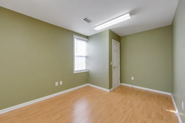 an empty room with windows and closet