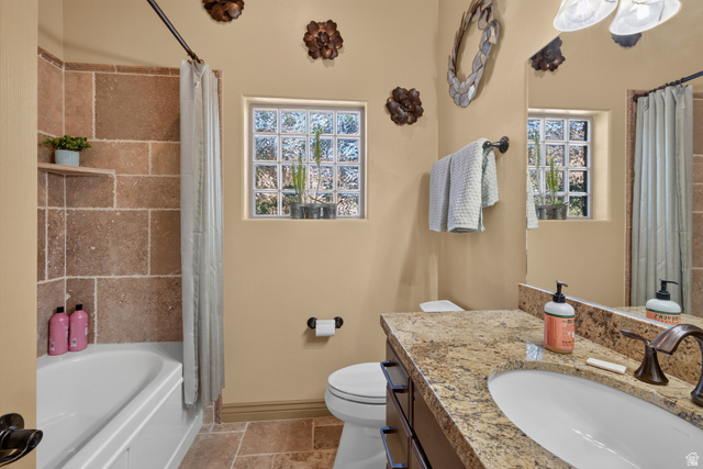 4635 East Sunny Acres Lane Moab, UT 84532 - Photo 29 of 56 Bathroom featuring a built-in tub with a stone-tiled surround and an integrated shelf