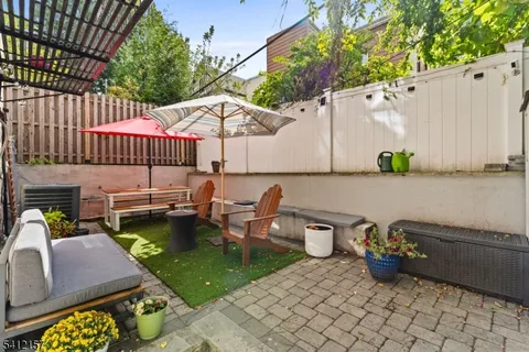 a view of a patio with table and chairs with wooden fence