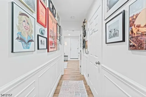 a view of a hallway with paintings on the wall