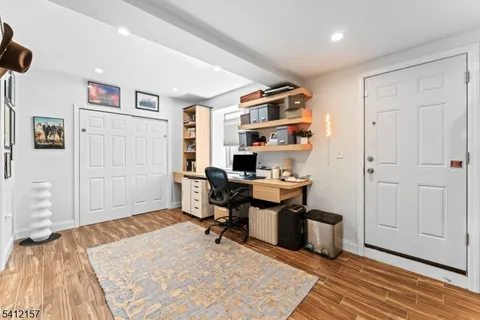 a workspace with a desk and chair with wooden floor