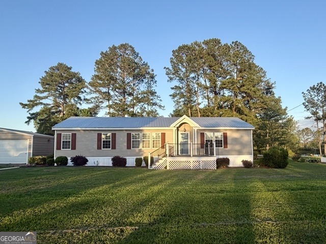 4338 Union Road Metter, GA 30439 - Photo 26 of 26 a front view of a house with a garden and trees