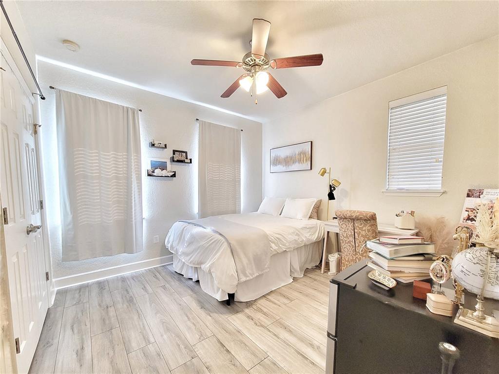 2508 Southwest 35th Place, Unit P91 Gainesville, FL 32608 - Photo 18 of 33 a bedroom with a bed and wooden floor