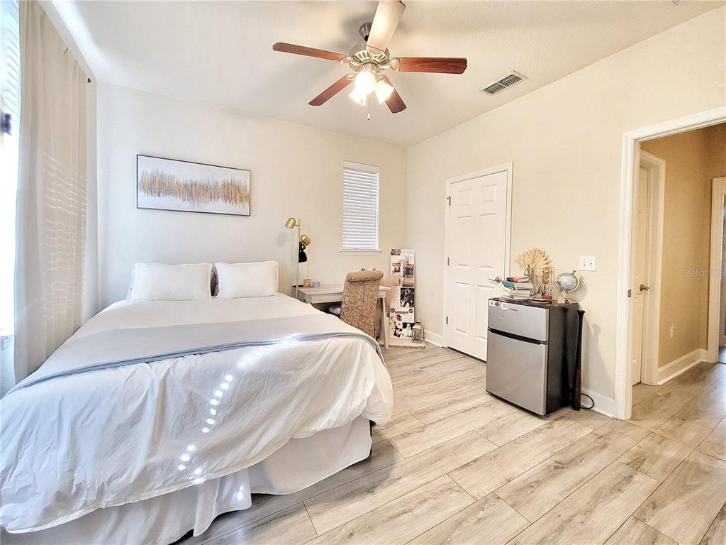 2508 Southwest 35th Place, Unit P91 Gainesville, FL 32608 - Photo 19 of 33 a spacious bedroom with a bed and a chandelier