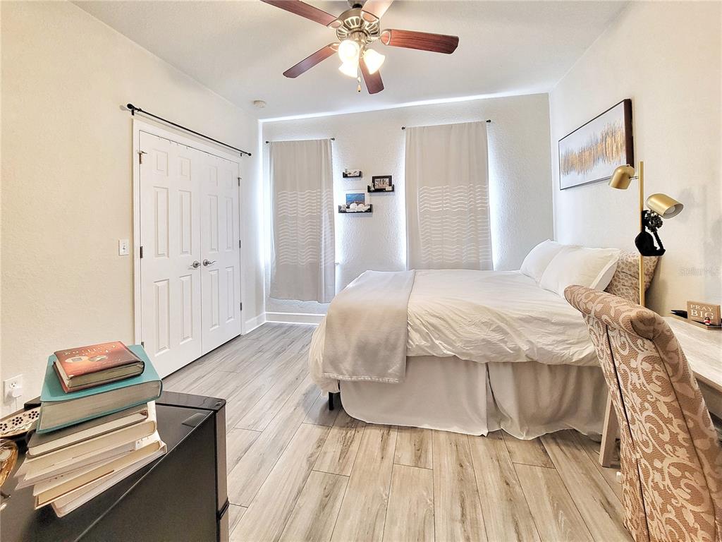 2508 Southwest 35th Place, Unit P91 Gainesville, FL 32608 - Photo 20 of 33 a bedroom with a bed and wooden floor