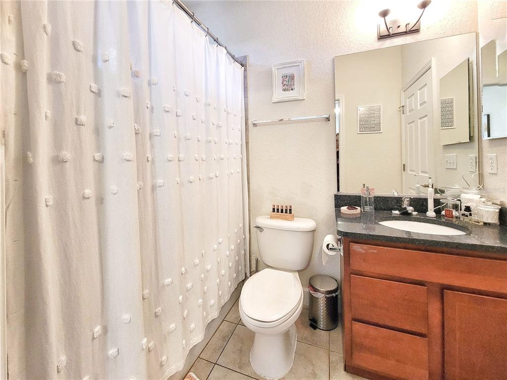 2508 Southwest 35th Place, Unit P91 Gainesville, FL 32608 - Photo 21 of 33 a bathroom with a toilet a sink and a mirror