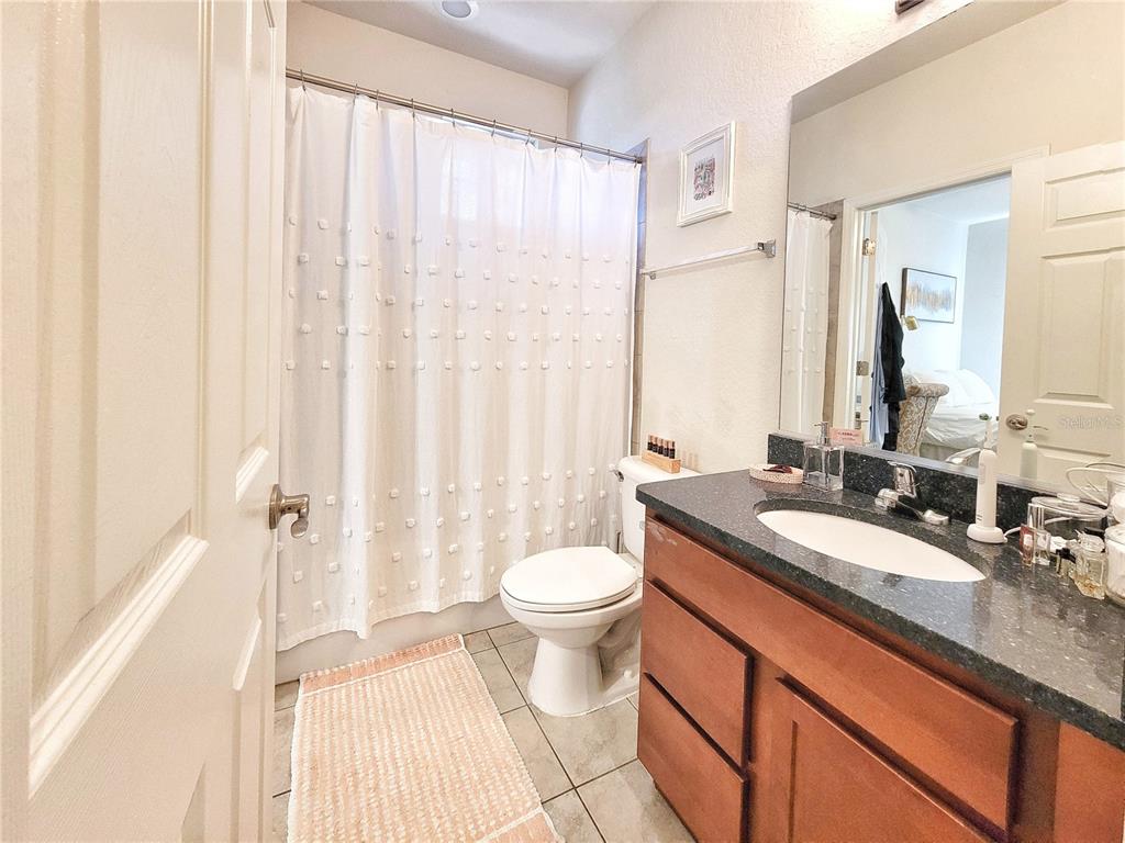 2508 Southwest 35th Place, Unit P91 Gainesville, FL 32608 - Photo 22 of 33 a bathroom with a granite countertop sink toilet and a mirror