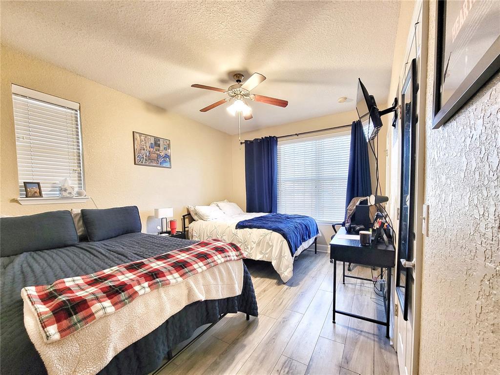 2508 Southwest 35th Place, Unit P91 Gainesville, FL 32608 - Photo 23 of 33 a bedroom with furniture a bed and a chandelier