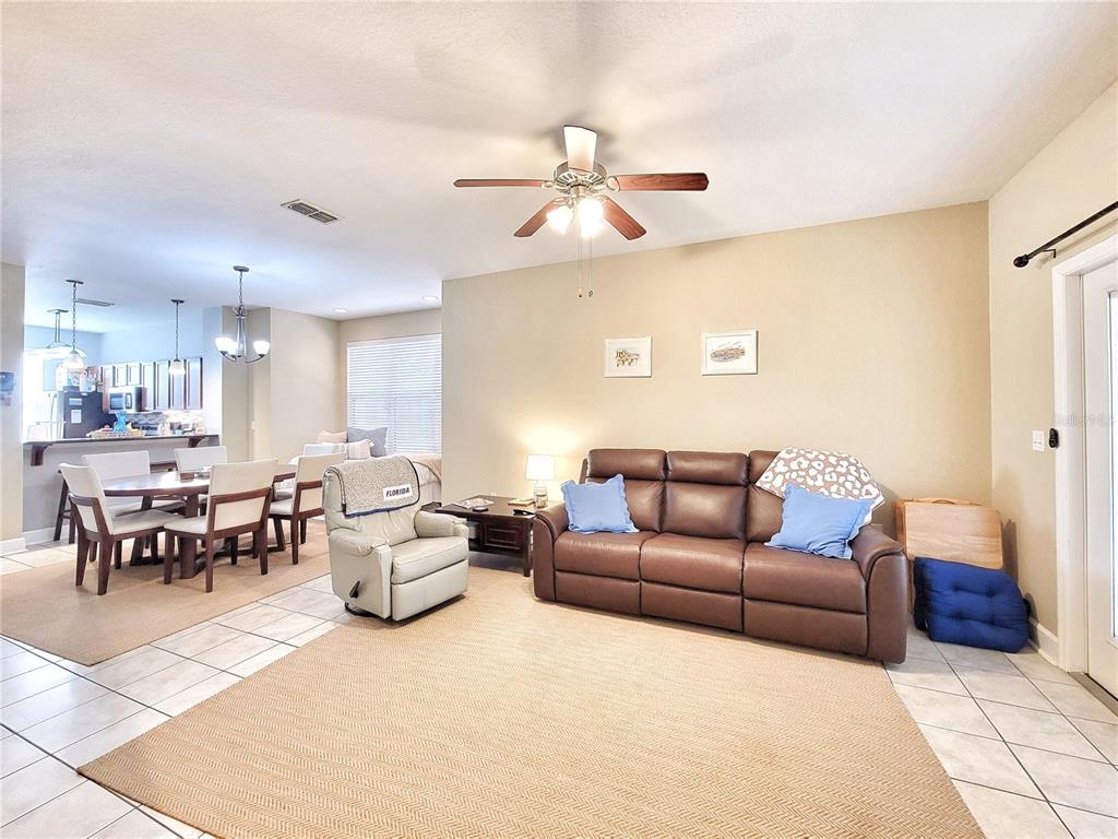 2508 Southwest 35th Place, Unit P91 Gainesville, FL 32608 - Photo 7 of 33 a living room with furniture a ceiling fan and a rug