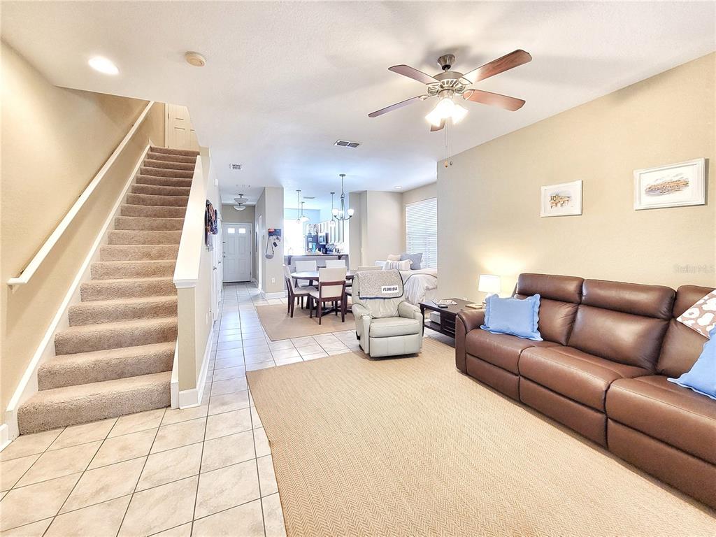 2508 Southwest 35th Place, Unit P91 Gainesville, FL 32608 - Photo 9 of 33 a living room with furniture and a chandelier
