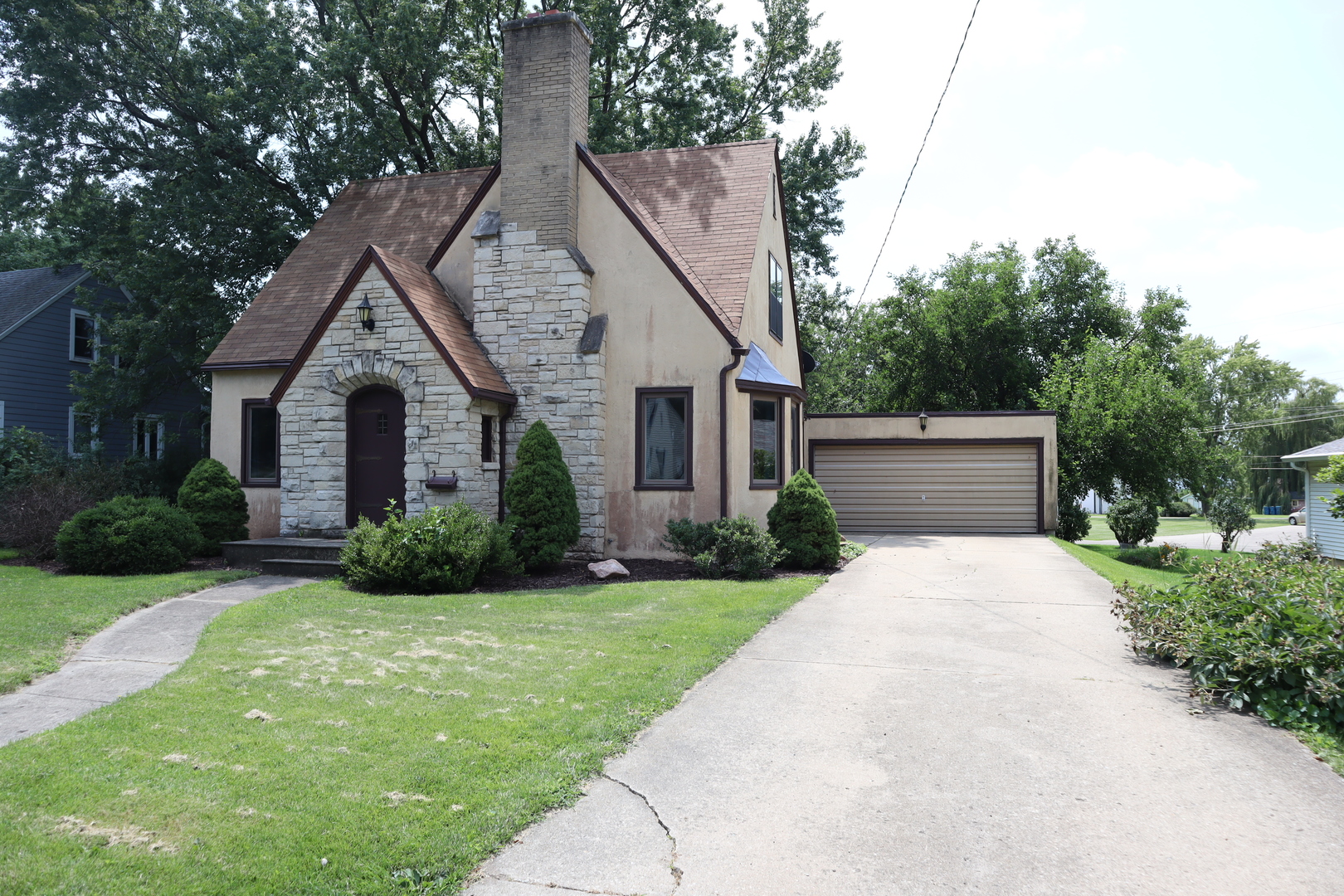 a front view of house with yard and green space